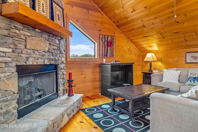 living room with vaulted ceiling, hardwood / wood-style floors, wooden ceiling, and wooden walls