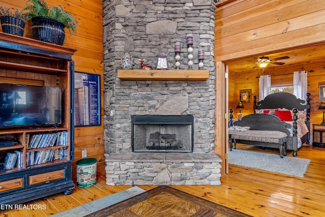 living room featuring hardwood / wood-style floors and wood walls