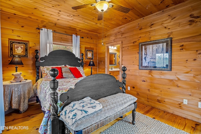 bedroom featuring wood ceiling, ceiling fan, wood-type flooring, and wooden walls