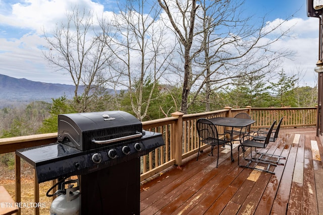 wooden deck featuring area for grilling and a mountain view