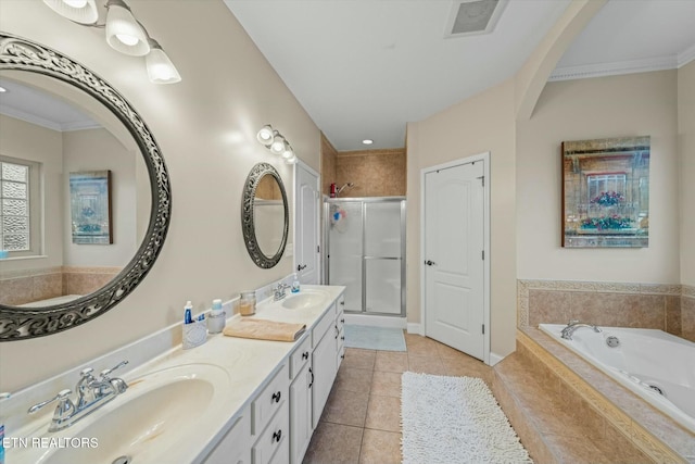 bathroom featuring plus walk in shower, vanity, crown molding, and tile patterned flooring