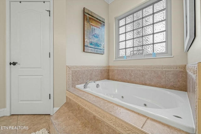 bathroom featuring tile patterned flooring and a relaxing tiled tub