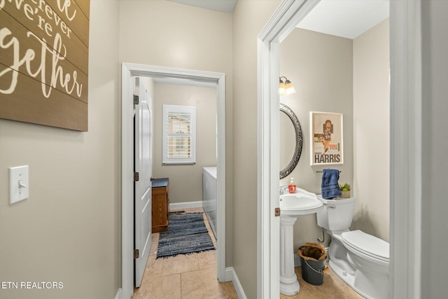 bathroom featuring toilet and tile patterned flooring