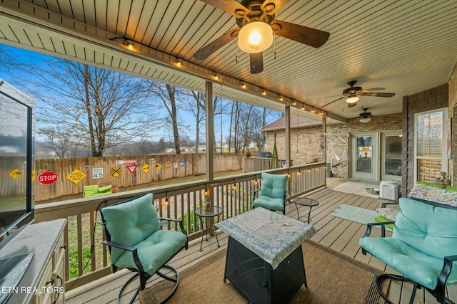 wooden terrace featuring ceiling fan