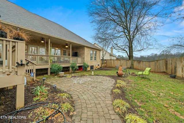 view of yard with a wooden deck and a patio