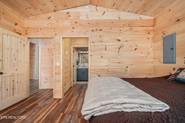 unfurnished bedroom featuring ensuite bathroom, electric panel, lofted ceiling, and wooden walls