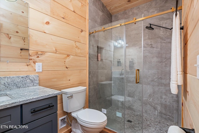 bathroom featuring toilet, vanity, wood walls, and a shower with shower door