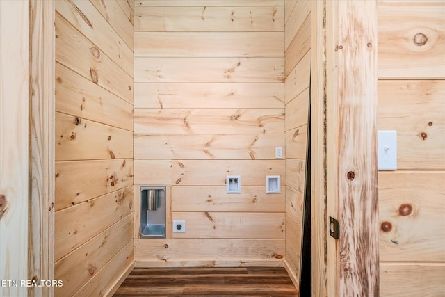 washroom featuring washer hookup, dark wood-type flooring, hookup for an electric dryer, and wood walls