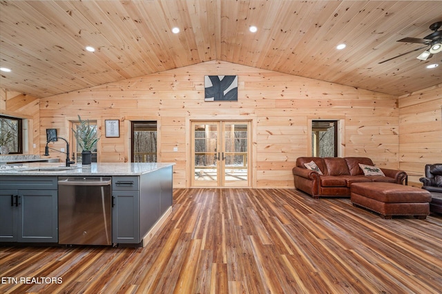 kitchen featuring gray cabinets, dishwasher, dark hardwood / wood-style flooring, and wooden walls