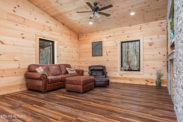 living room with ceiling fan, dark hardwood / wood-style flooring, wood ceiling, and wood walls