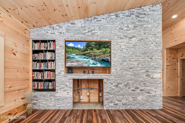 details featuring wood-type flooring, wood walls, and built in shelves