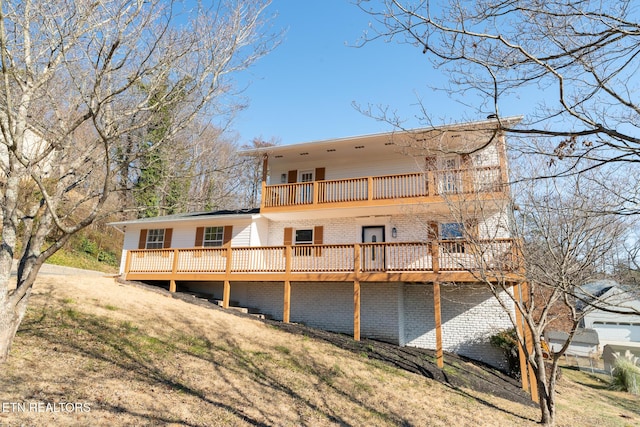 rear view of house featuring a yard