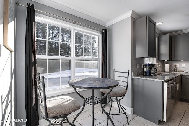 kitchen with sink, light tile patterned floors, ornamental molding, and light stone countertops