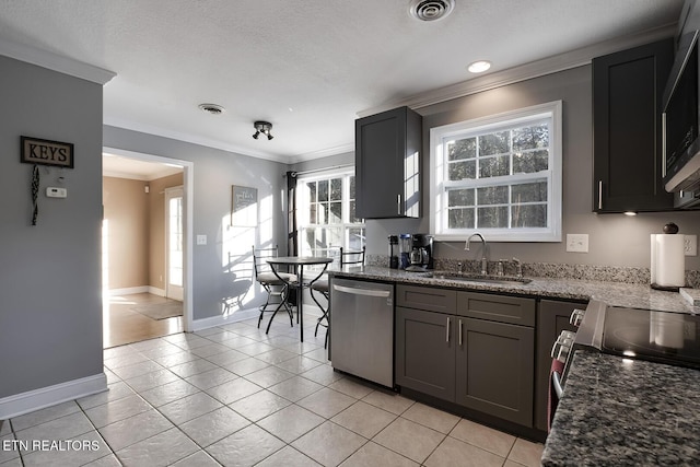 kitchen featuring sink, stainless steel dishwasher, dark stone counters, and light tile patterned flooring