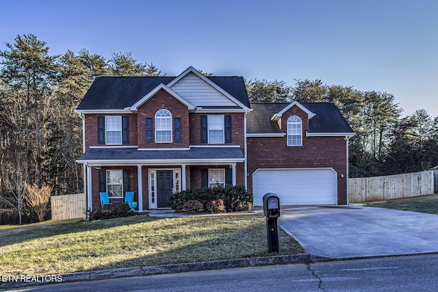 view of front of house with a garage, a front lawn, and covered porch