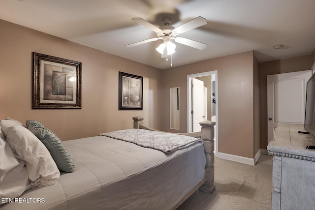 carpeted bedroom featuring ceiling fan and connected bathroom