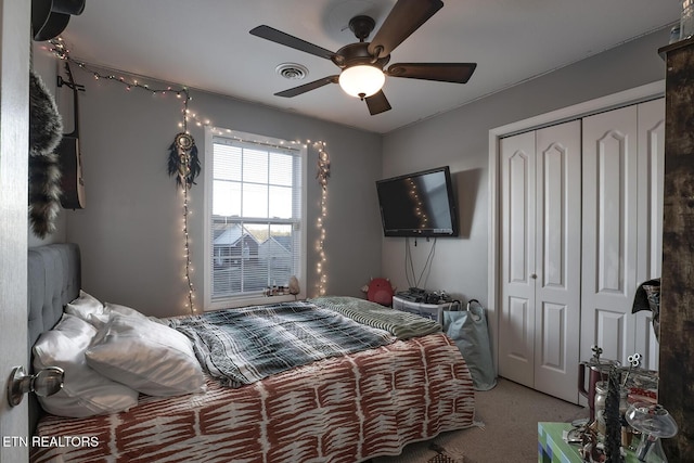 carpeted bedroom featuring ceiling fan and a closet