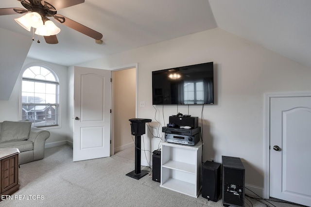 living room with ceiling fan, light colored carpet, and lofted ceiling