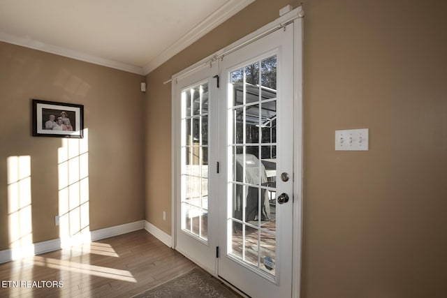 doorway featuring ornamental molding and light hardwood / wood-style floors