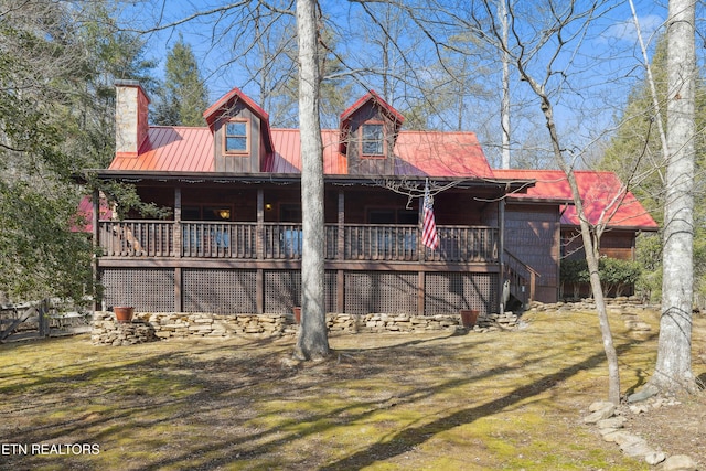 rear view of house featuring a yard