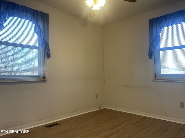 spare room with hardwood / wood-style flooring and ceiling fan