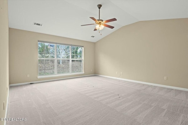 carpeted empty room with vaulted ceiling and ceiling fan