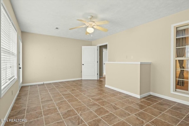 unfurnished room featuring ceiling fan and tile patterned floors