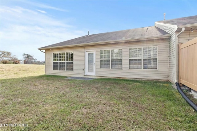 rear view of house with a yard