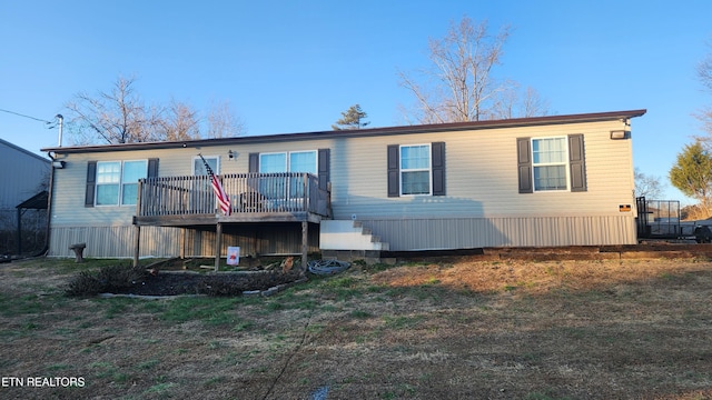 back of house featuring a wooden deck