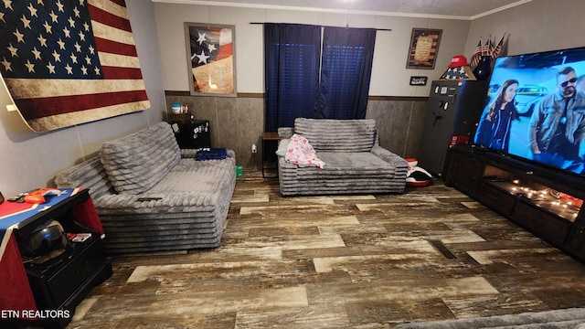 sitting room with ornamental molding and dark hardwood / wood-style flooring