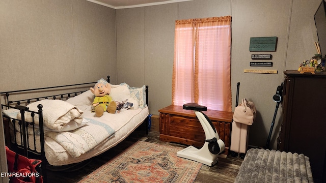 bedroom featuring dark hardwood / wood-style floors and ornamental molding