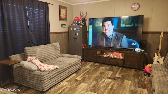 cinema room with hardwood / wood-style floors, ornamental molding, and tile walls