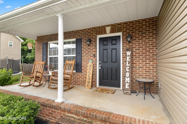 view of exterior entry with a porch