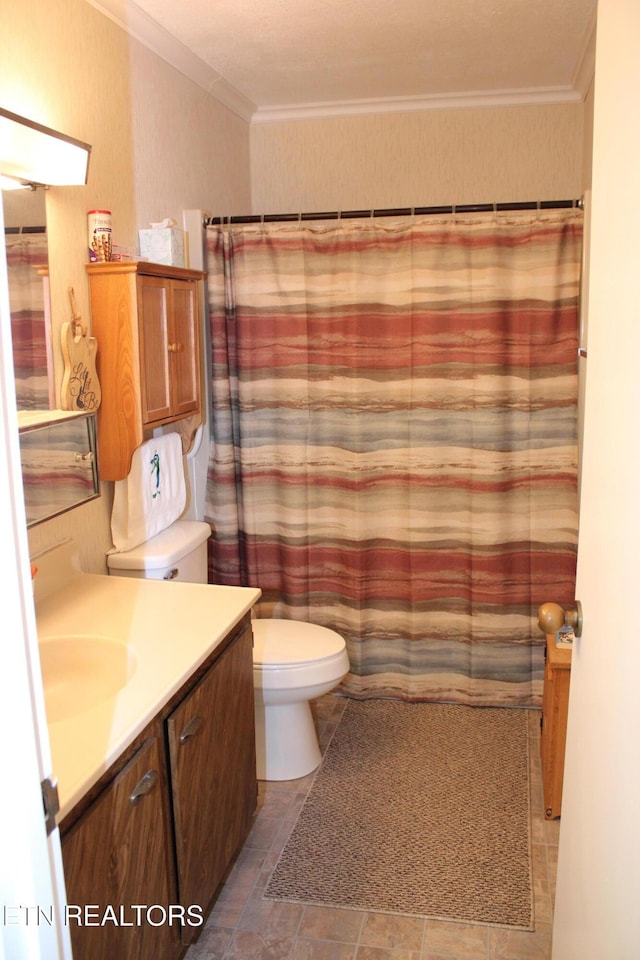 bathroom featuring toilet, ornamental molding, walk in shower, and vanity