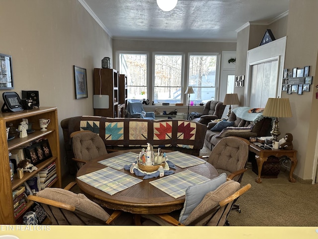 dining space featuring a textured ceiling, crown molding, and carpet floors