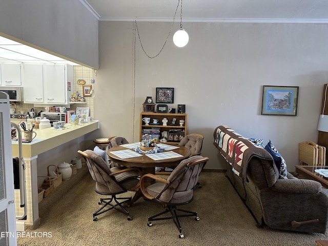 carpeted dining area with crown molding