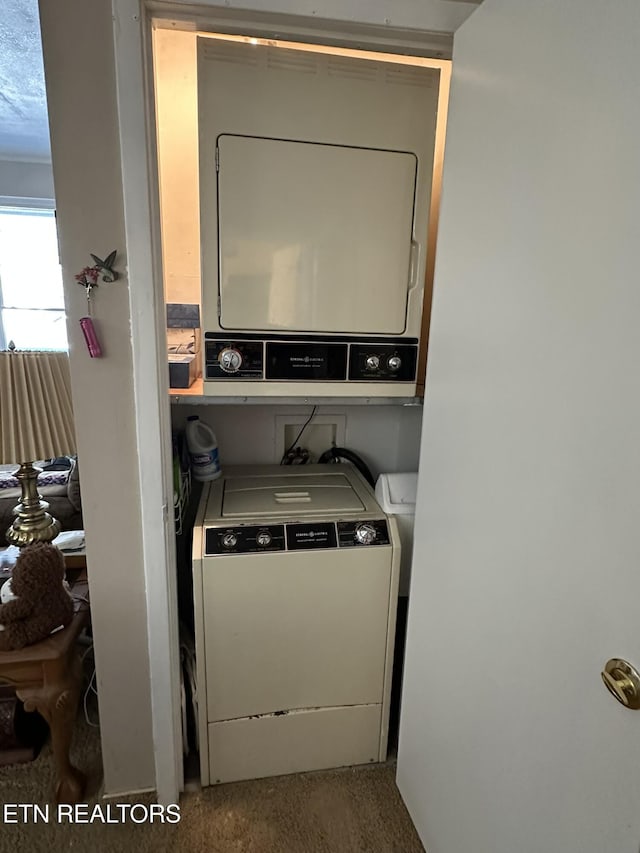 laundry room featuring stacked washer and clothes dryer