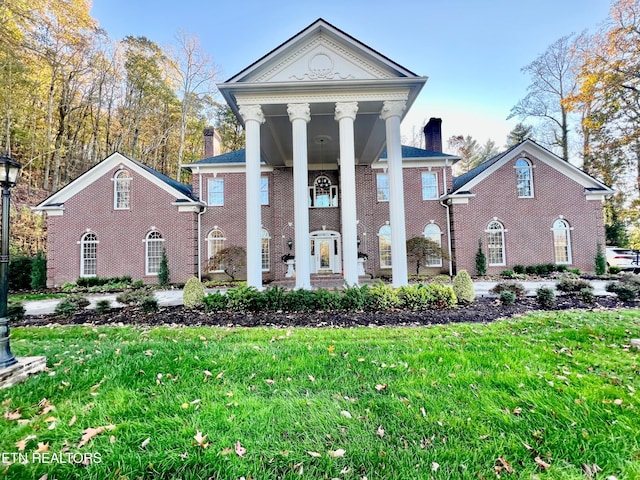 greek revival house featuring a front lawn