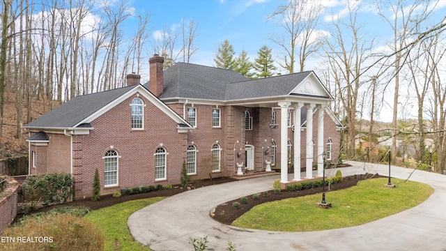 neoclassical / greek revival house with a front lawn