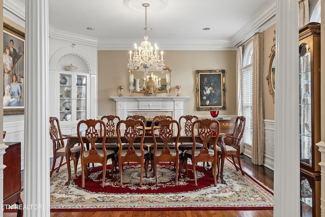 dining room with crown molding, wood-type flooring, and a chandelier