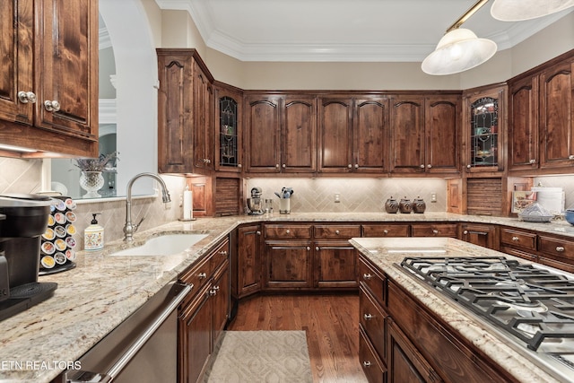 kitchen with stainless steel appliances, sink, dark brown cabinetry, and dark hardwood / wood-style flooring