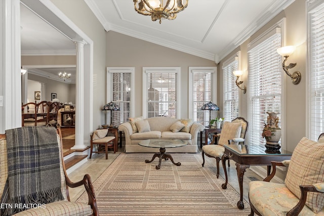 sunroom / solarium featuring lofted ceiling, a chandelier, and decorative columns