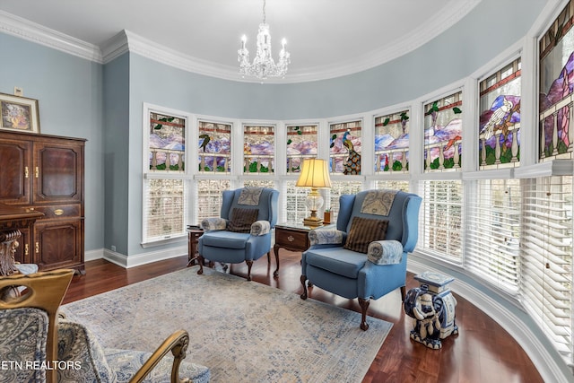 sitting room with ornamental molding, plenty of natural light, dark wood-type flooring, and a notable chandelier