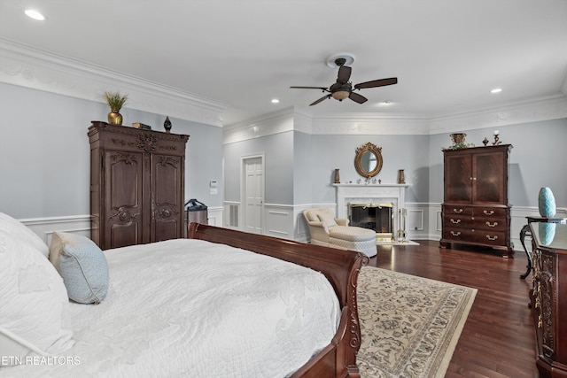 bedroom featuring ornamental molding, ceiling fan, and dark hardwood / wood-style flooring