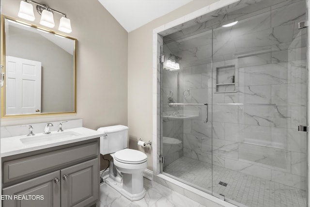 bathroom featuring vanity, an enclosed shower, and toilet