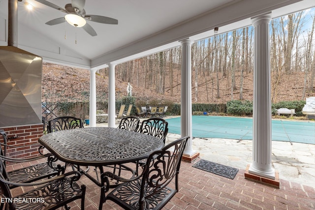 sunroom / solarium featuring ceiling fan, lofted ceiling, and decorative columns