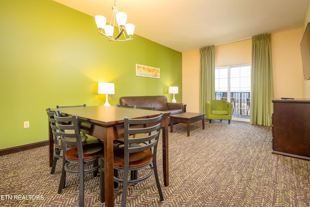 dining area with dark carpet and a notable chandelier