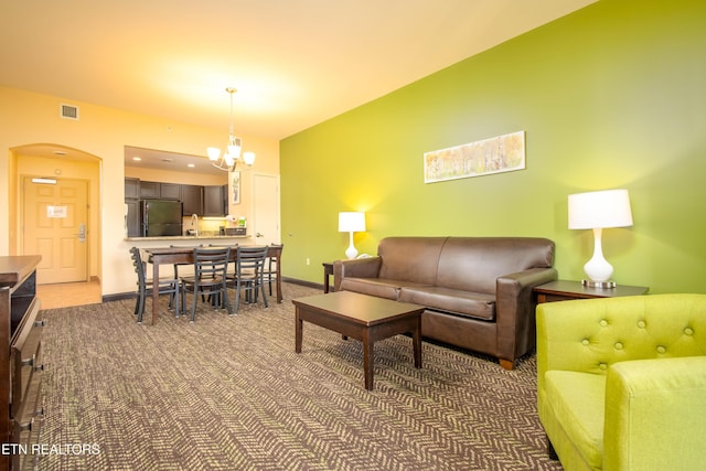 carpeted living room with sink and an inviting chandelier