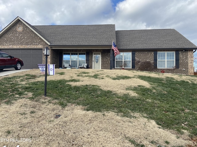 ranch-style home with a front lawn and a garage