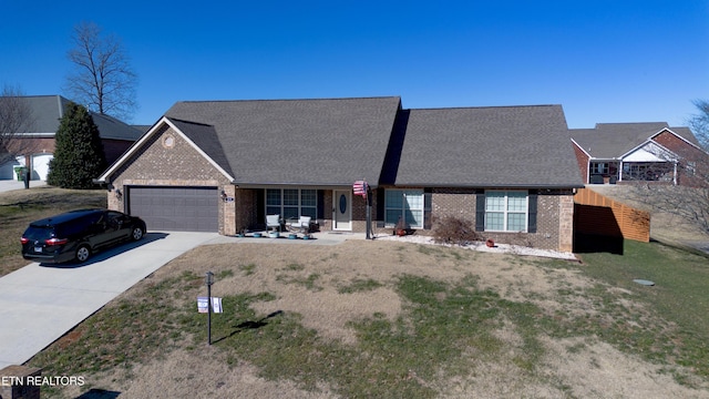 single story home featuring a front lawn and a garage